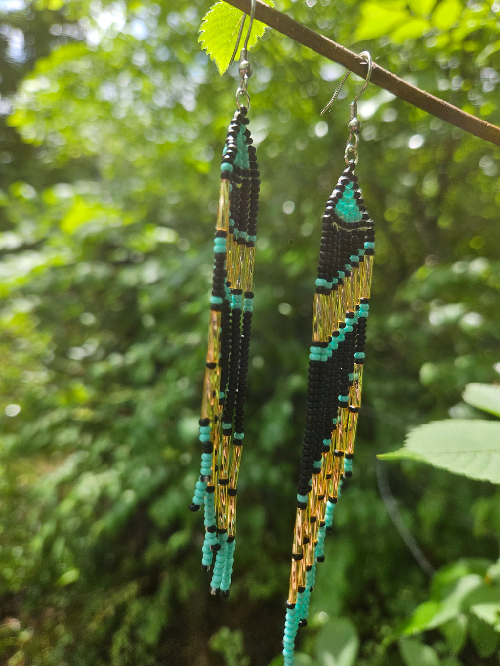 Handmade turquoise and gold beaded fringe earrings featuring intricate beadwork and a bold statement design. Perfect for boho fashion lovers and unique jewelry collections.