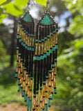Handmade turquoise and gold beaded fringe earrings featuring intricate beadwork and a bold statement design. Perfect for boho fashion lovers and unique jewelry collections.