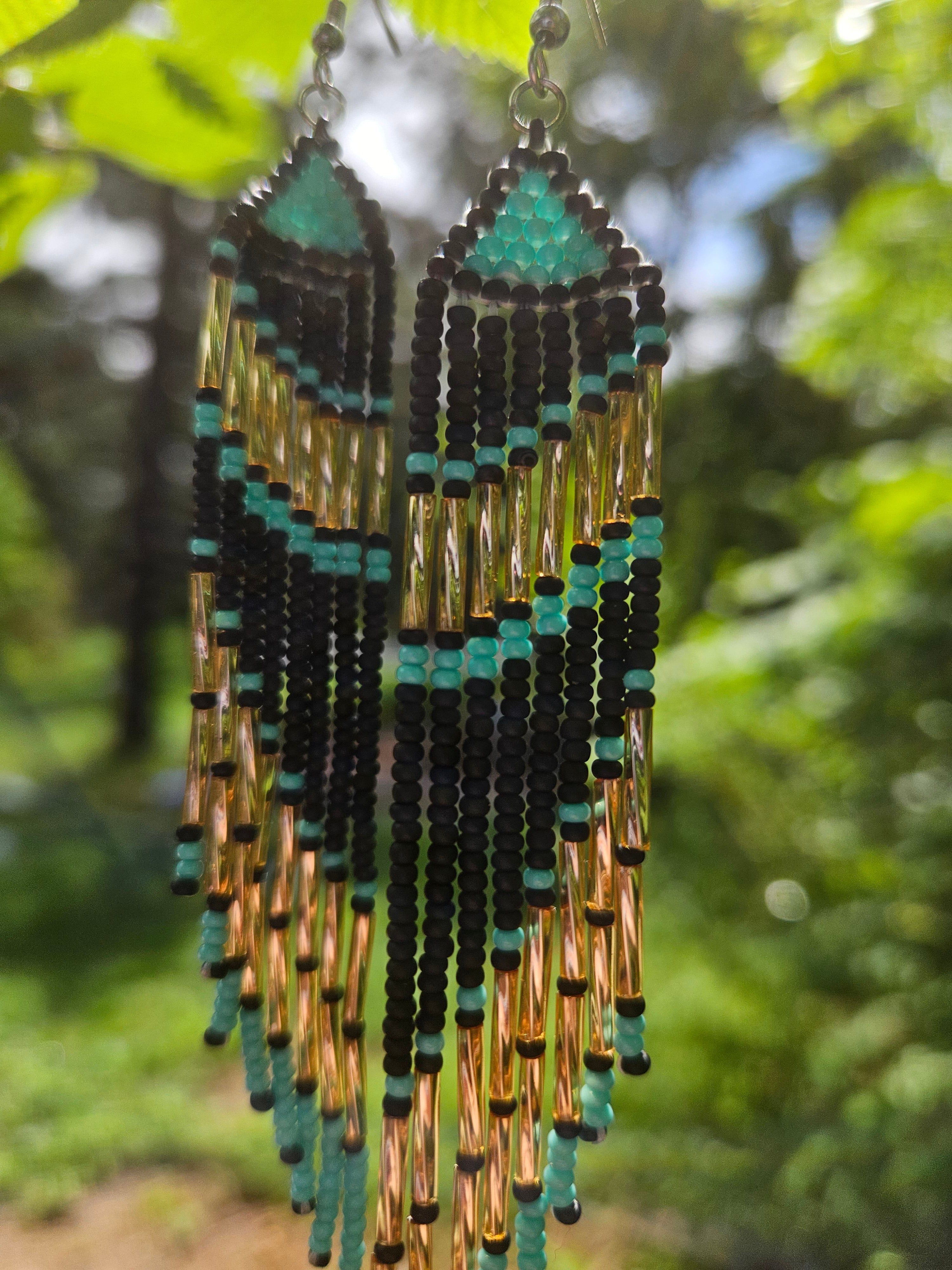 Handmade turquoise and gold beaded fringe earrings featuring intricate beadwork and a bold statement design. Perfect for boho fashion lovers and unique jewelry collections.